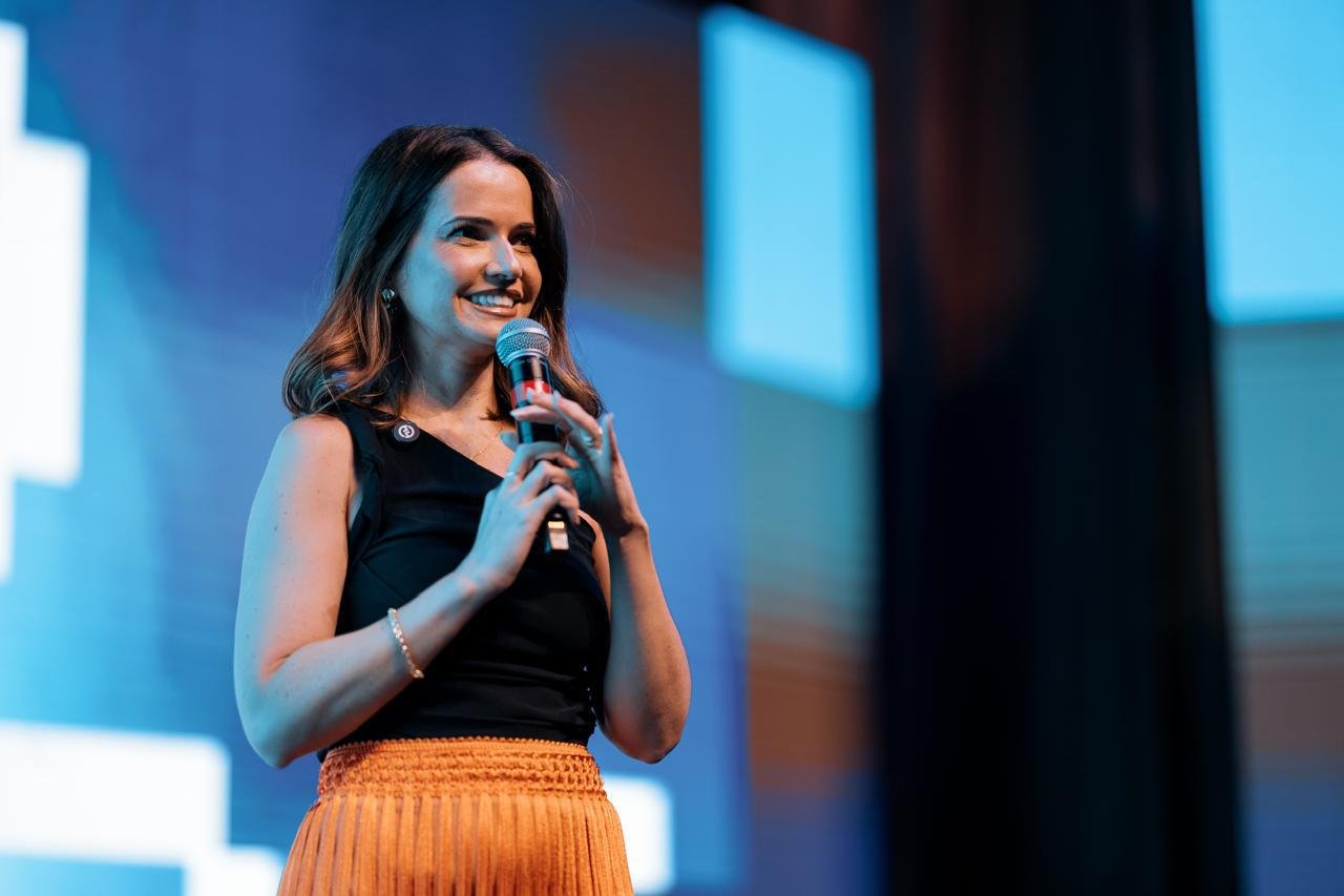 Dani Venâncio palestrando em evento com microfone